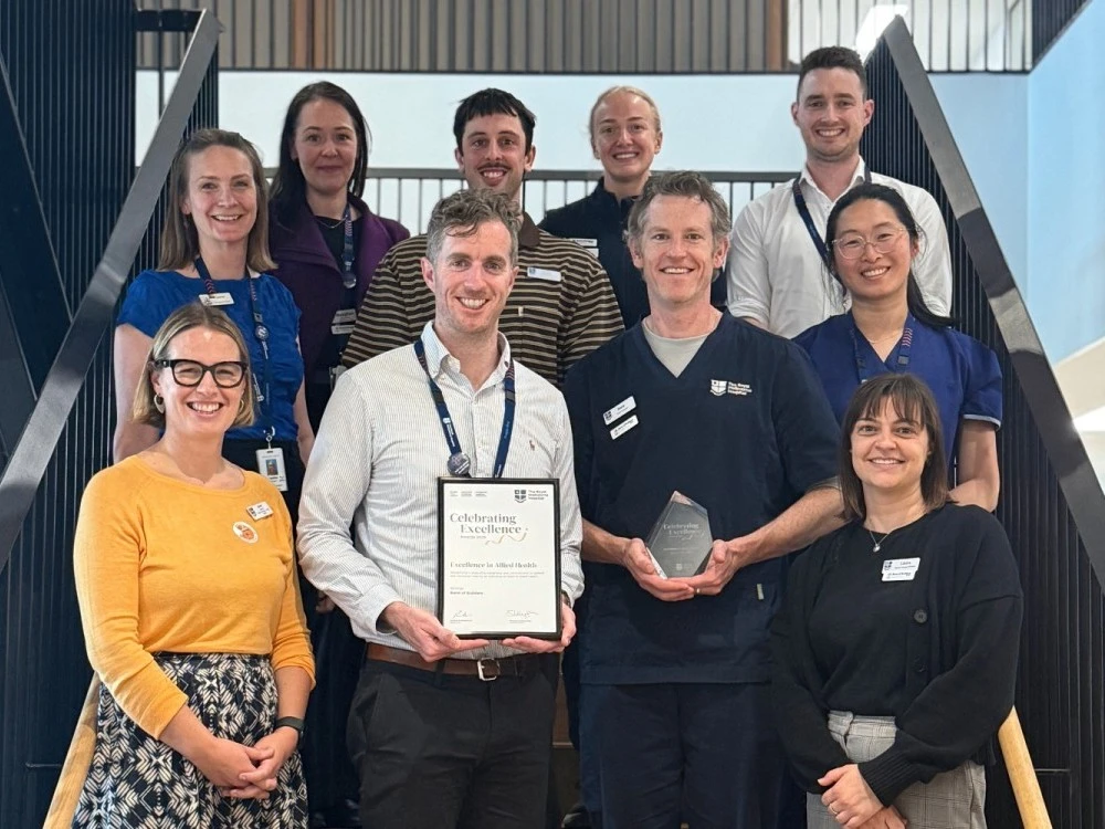 band-of-builders-team-standing-with-celebrating-excellence-2025-award.jpg