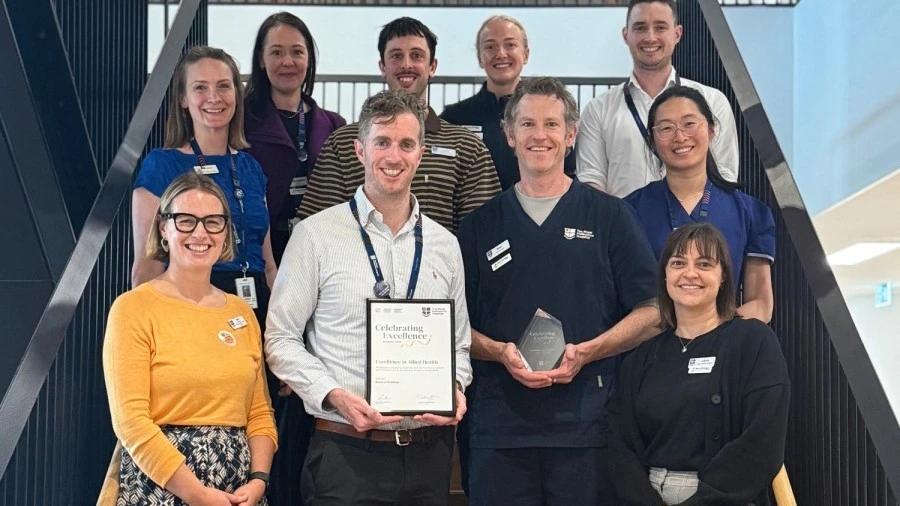 band-of-builders-team-standing-with-celebrating-excellence-2025-award.jpg