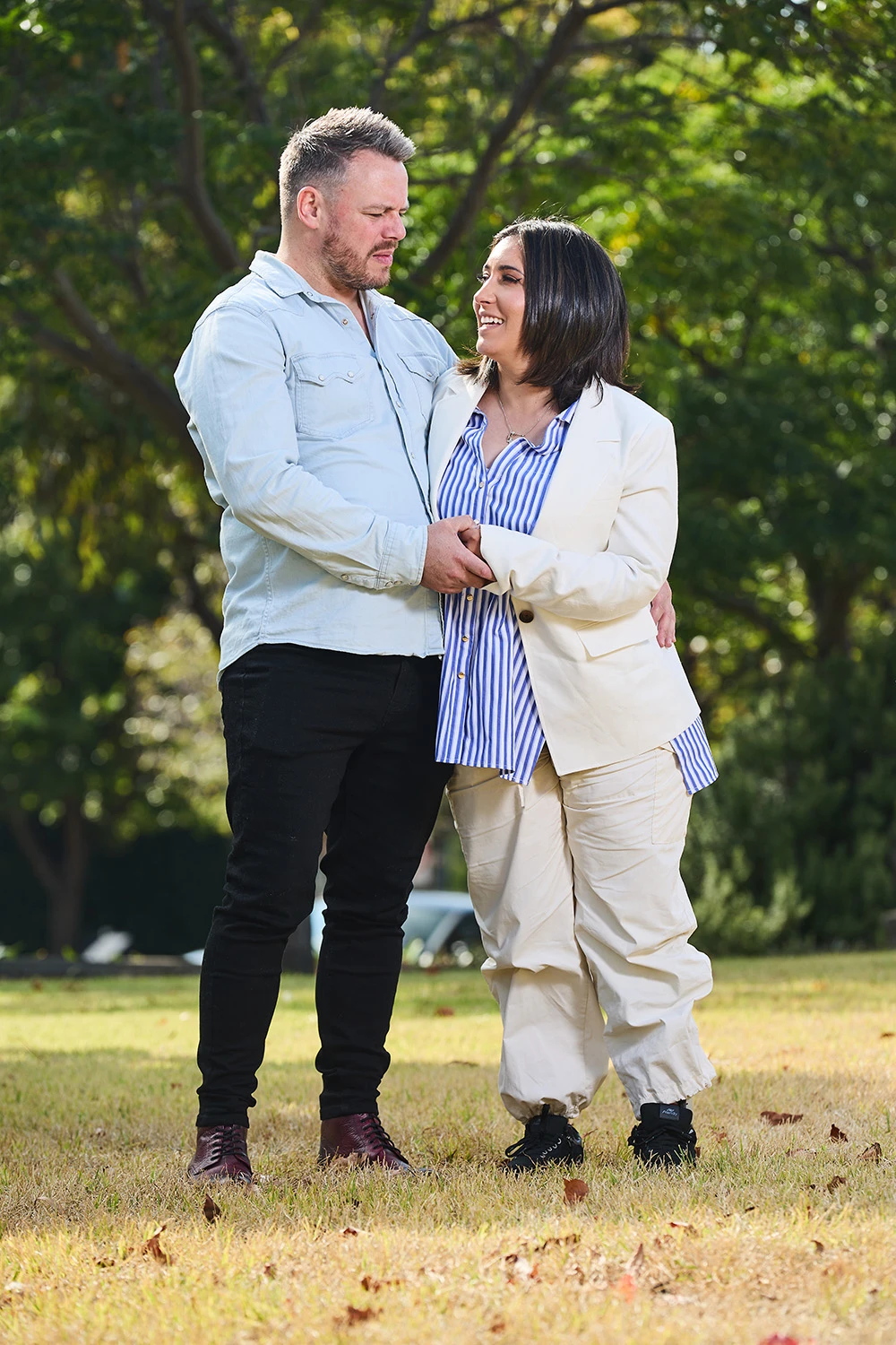 Brianna standing with support from her husband