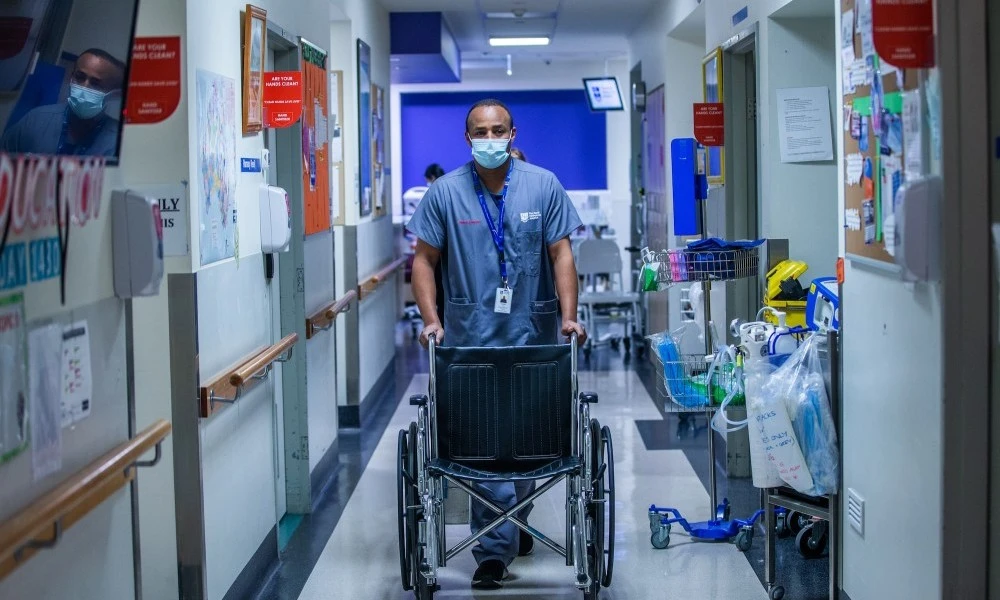 Clinical assistant pushing wheelchair