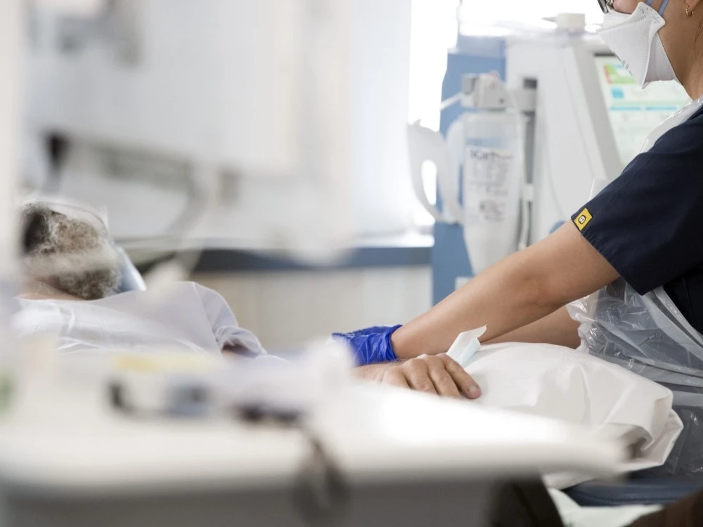 Close up of Kidney Care nurse holding patient's hand