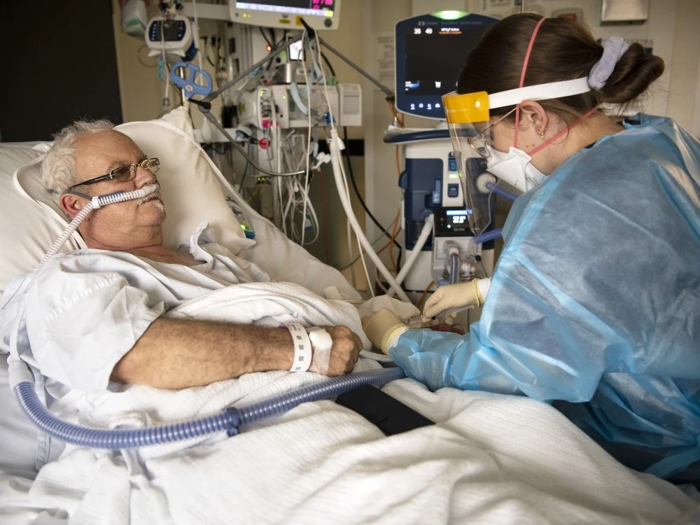 COVID-19 patient in the ICU with staff member
