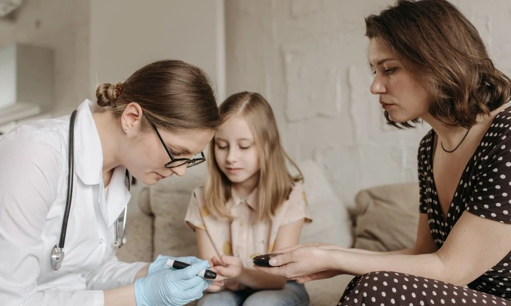 Doctor checking child's blood sugar