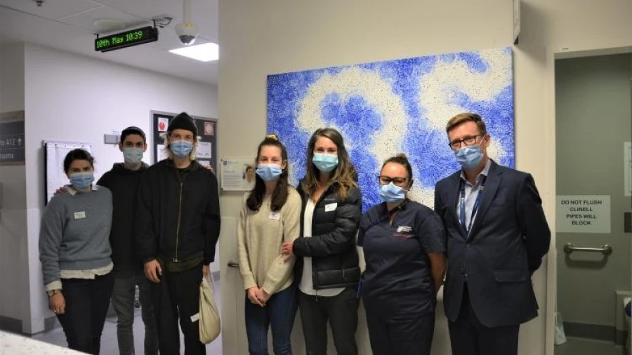 ED patient's family with artwork donated in memoriam