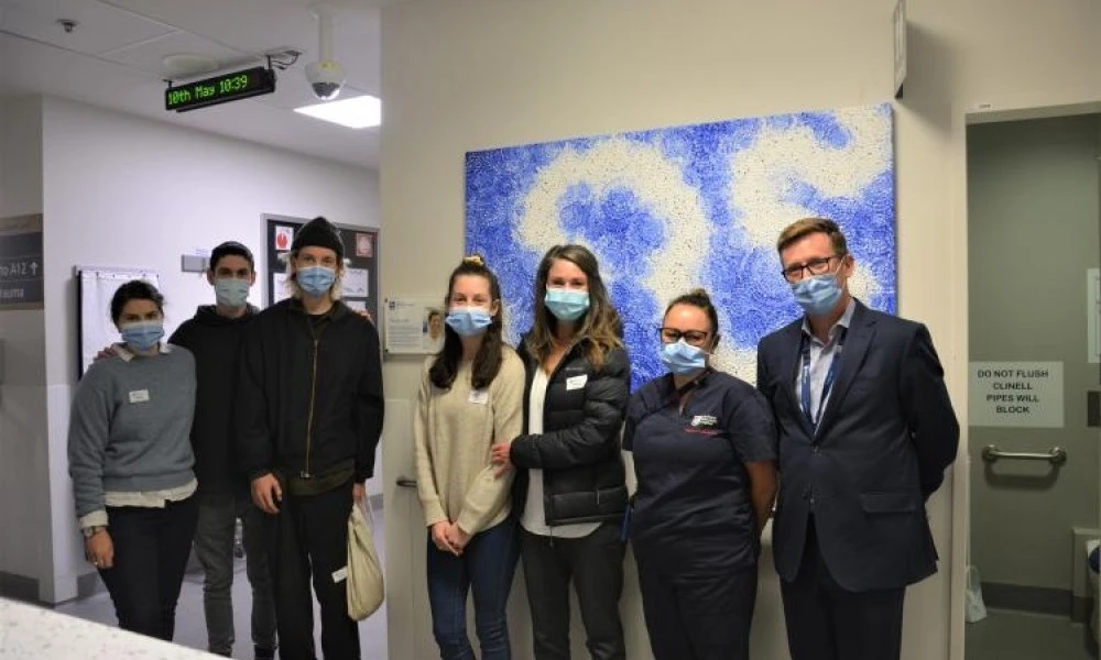 ED patient's family with artwork donated in memoriam