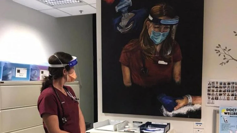 Emergency doctor Dr Emma West with her portrait painted by colleague Dr Amaali Lokuge