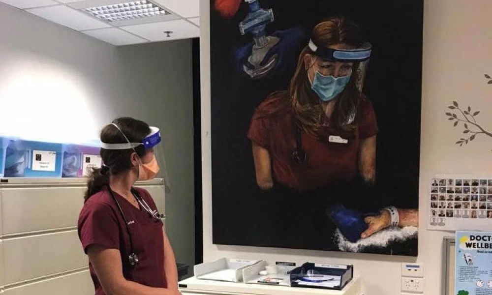 Emergency doctor Dr Emma West with her portrait painted by colleague Dr Amaali Lokuge
