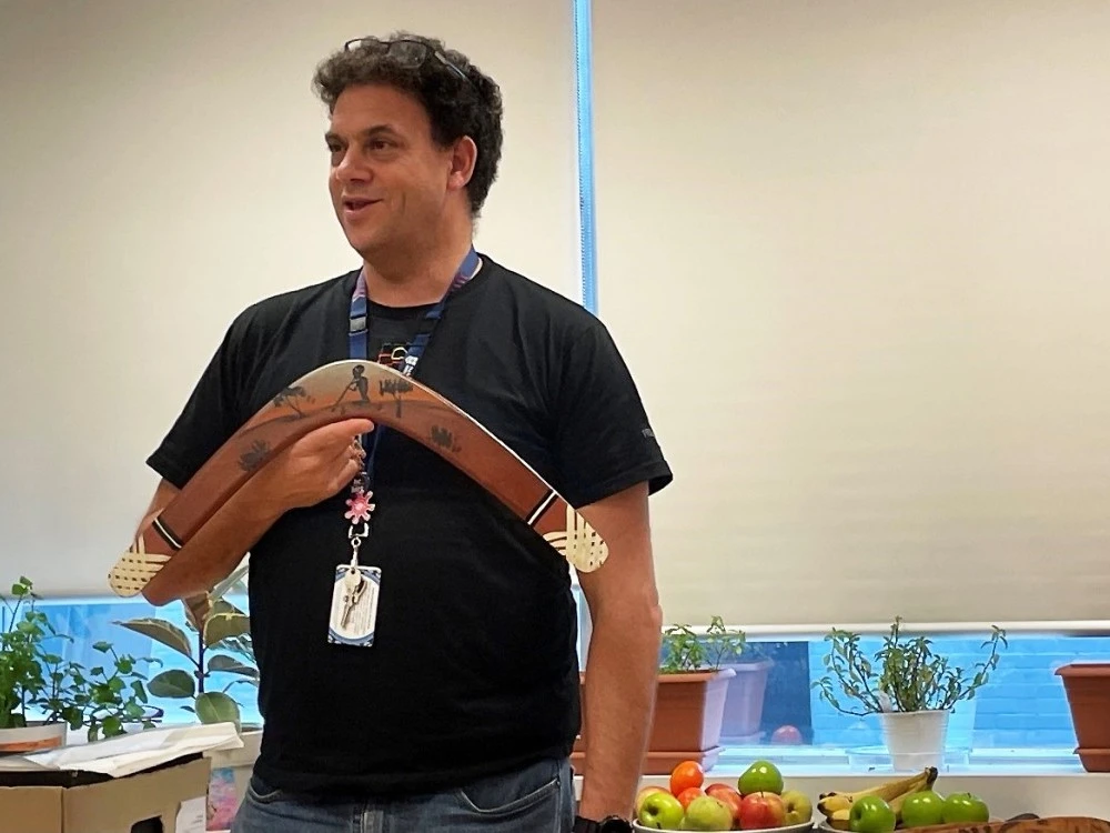 Staff member from the First Nations Social and Emotional Wellbeing team holding a boomerang