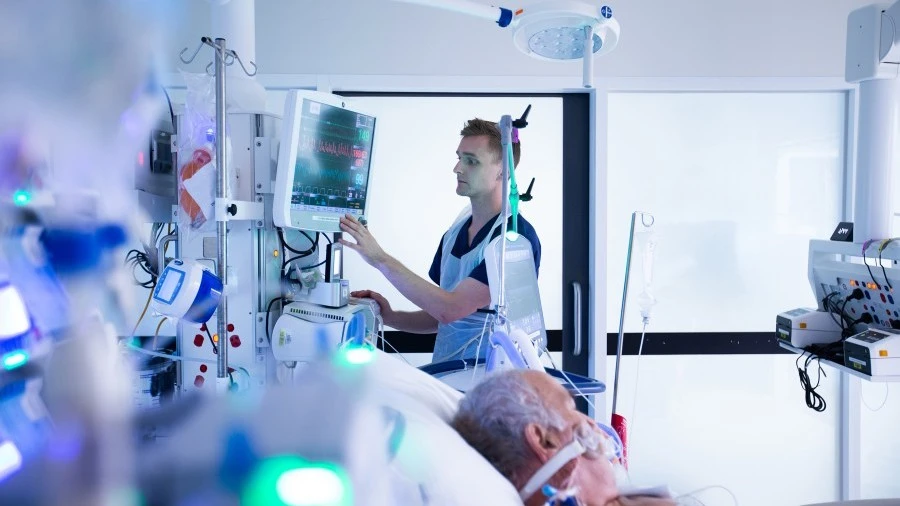 ICU nurse caring for a seriously unwell patient