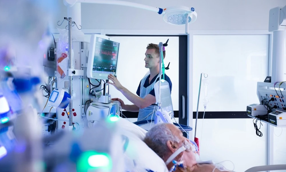 ICU nurse caring for a seriously unwell patient
