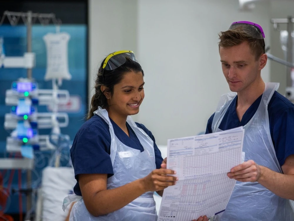 Two ICU nurses looking at chart