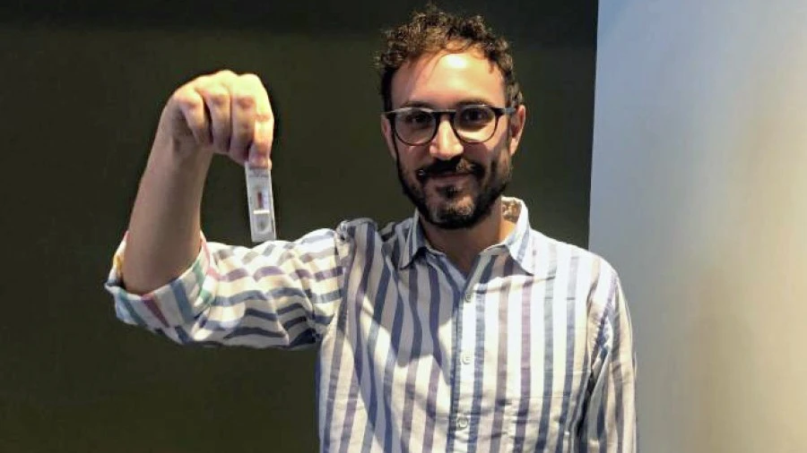 Man holding rapid antigen test