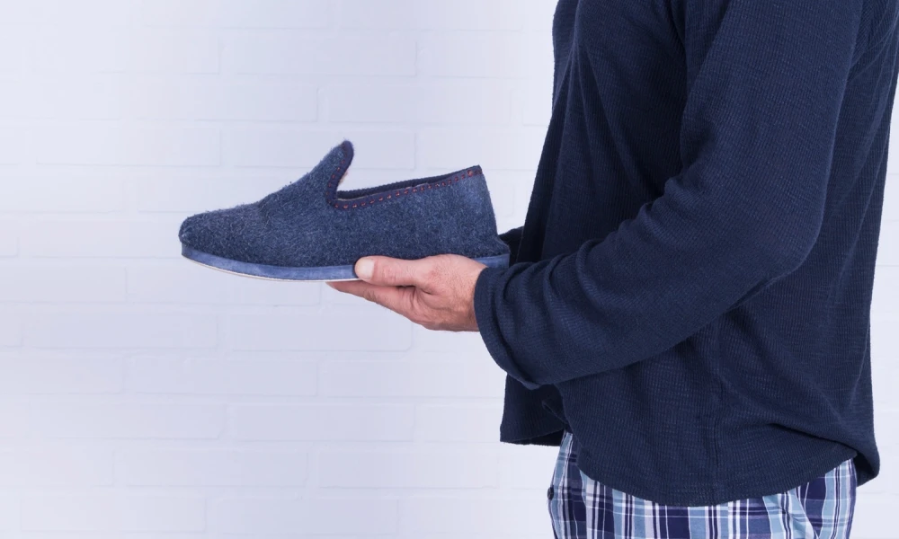 Man in pyjamas with a slipper