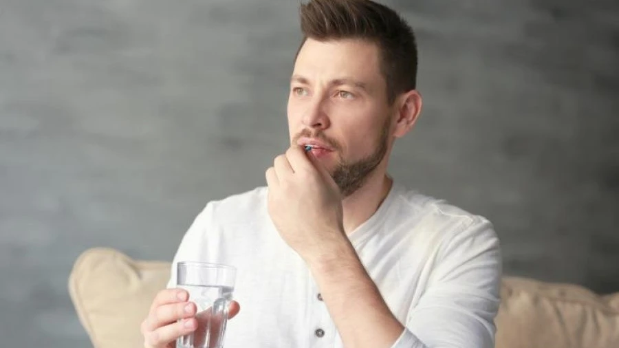 Man taking tablet