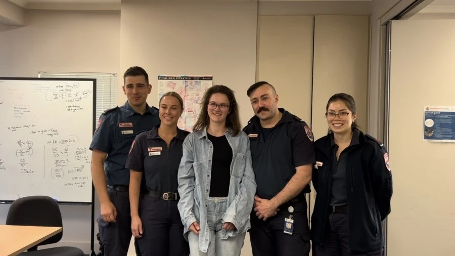 Former patient Meg with paramedics