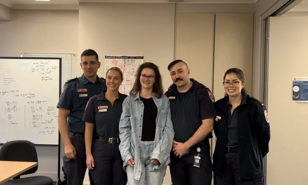 Former patient Meg with paramedics