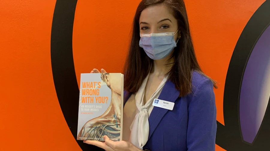 Neurology registrar Dr Sarah Holper with her book titled 'What's Wrong With You? An Insider's Guide To Your Insides'