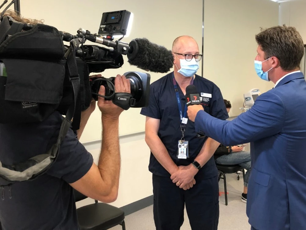 7 News reporter and camera operator interview doctor