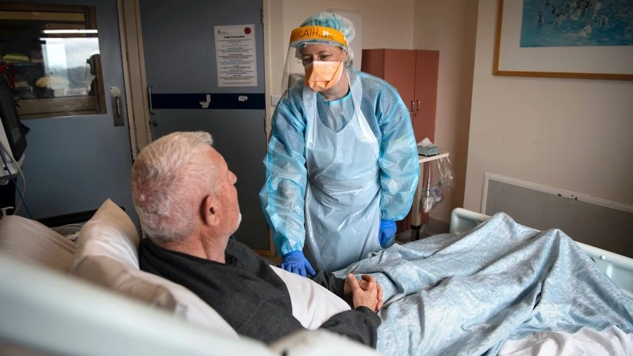 Nurse with patient on infectious diseases ward
