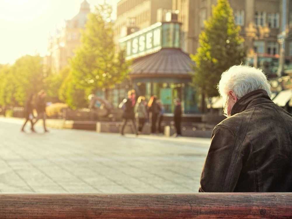 Older person sitting on park bench