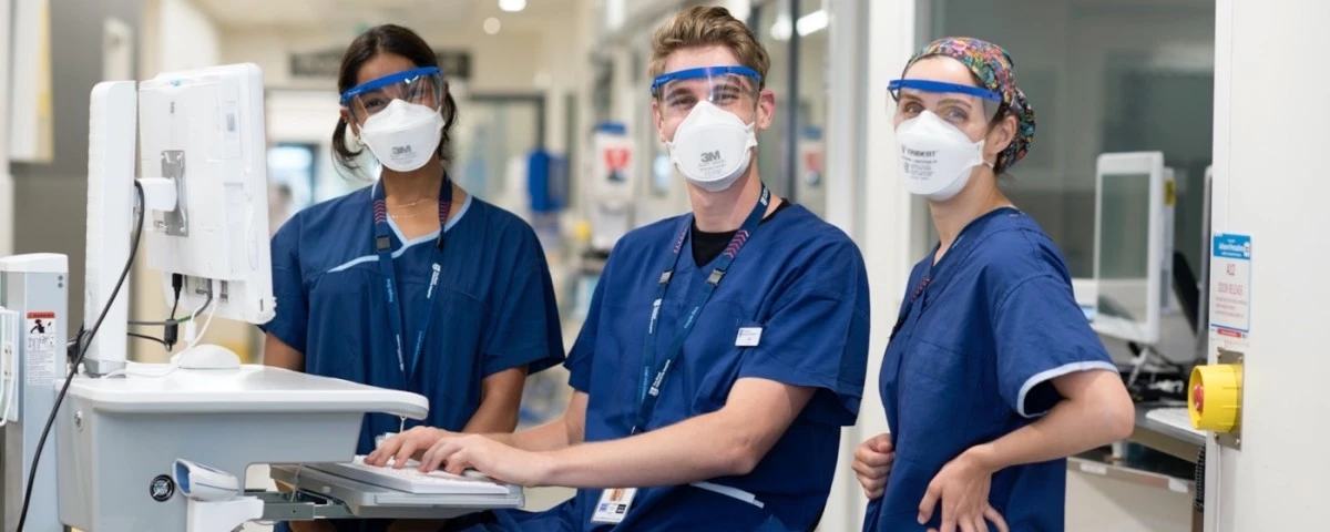 Three staff members at a workstation