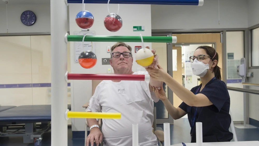Neurology and Stroke physio assisting patient with coordination
