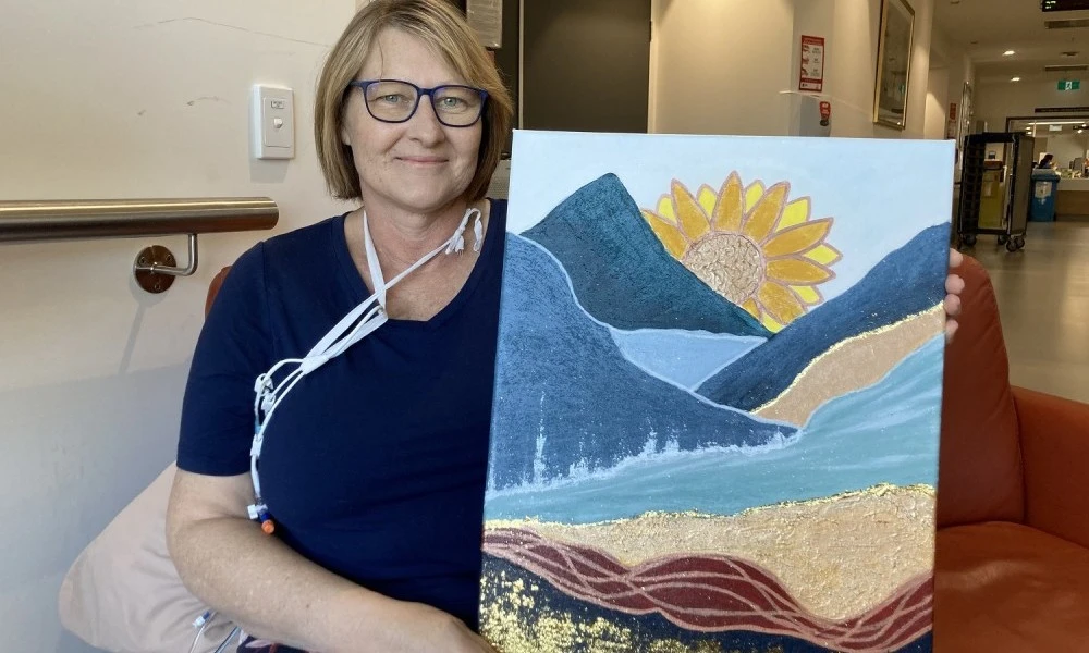 Patient Mirisa with her sunflower painting