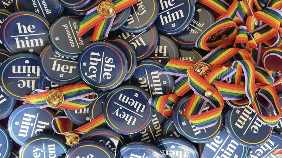 Pronoun pins and rainbow ribbons