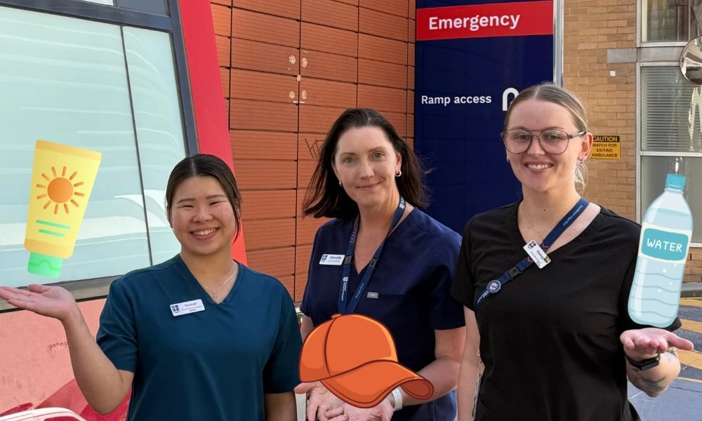 ED staff Hannah, Danielle and Kelsey pose with sunscreen, hat and water emojis outside the RMH Emergency Department