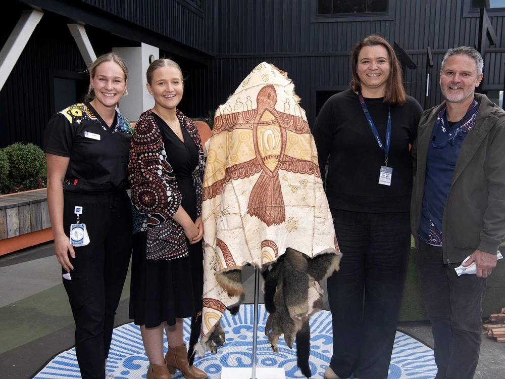 RMH staff with Possum Skin Cloak