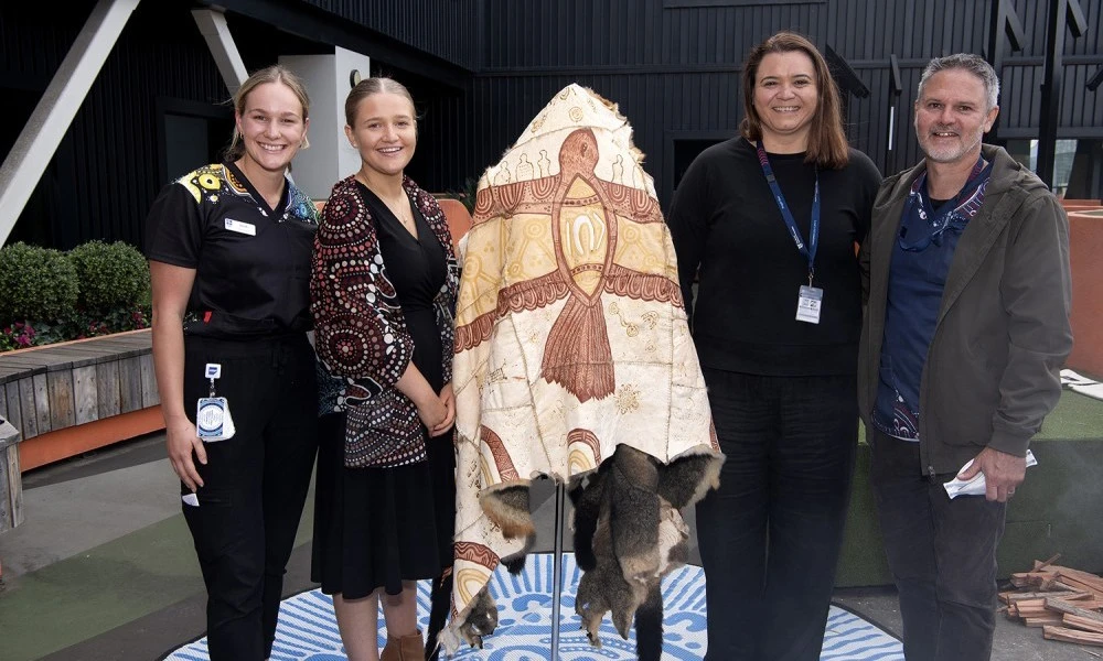 RMH staff with Possum Skin Cloak