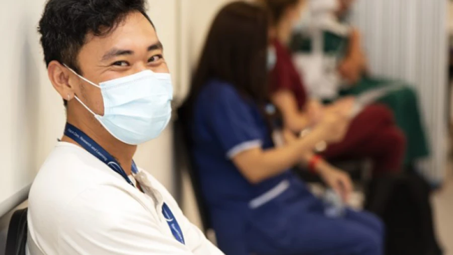 Staff member waiting for COVID-19 vaccination