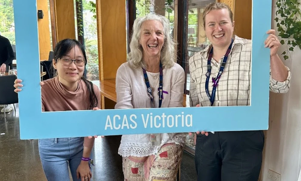 Three women holding sign that says Listen to older people - ACAS Victoria