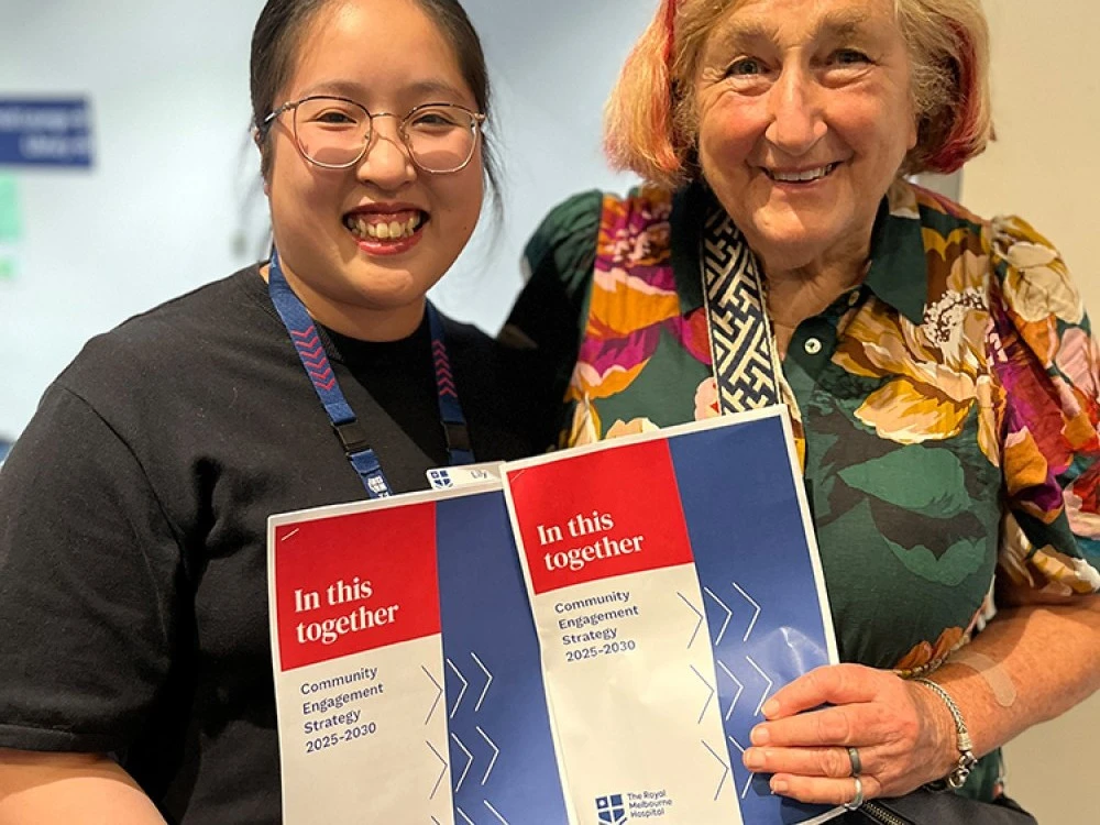 Two women hold the new RMH Community Engagement Strategy