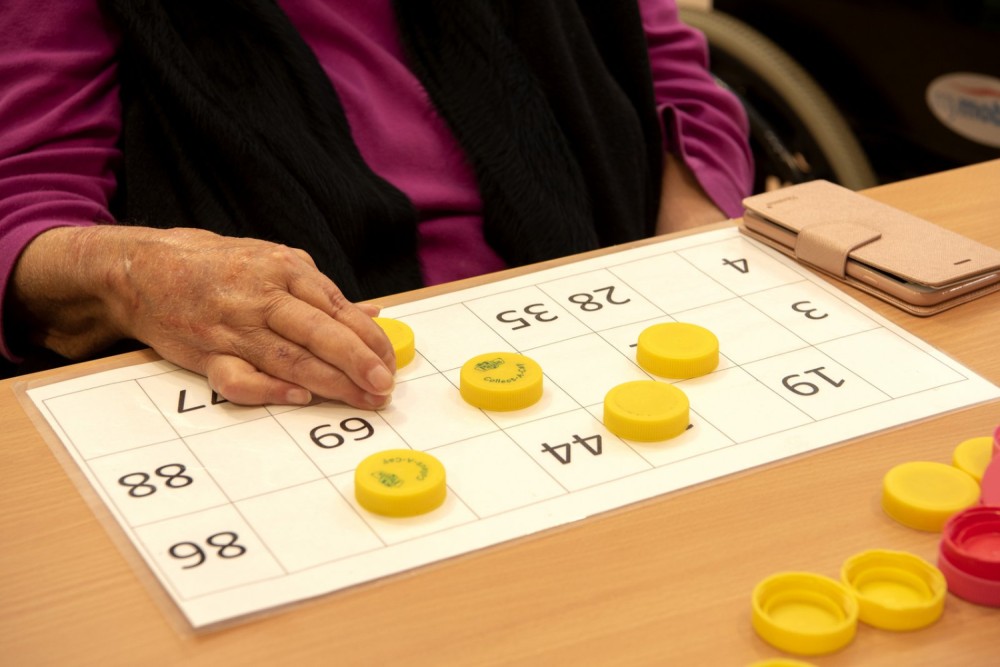 Close up view of residents hands playing numbers game at Cyril Jewell House