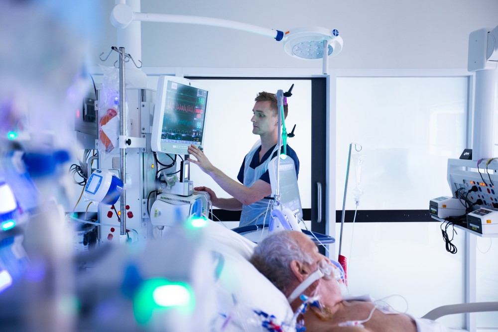ICU nurse caring for a seriously unwell patient