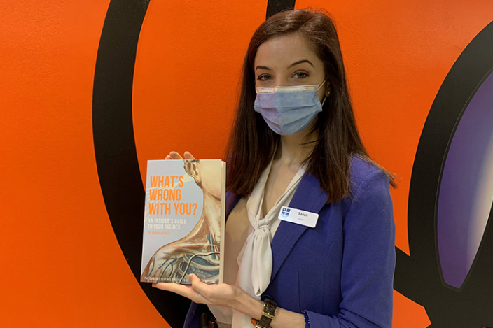 Neurology registrar Dr Sarah Holper with her book titled 'What's Wrong With You? An Insider's Guide To Your Insides'