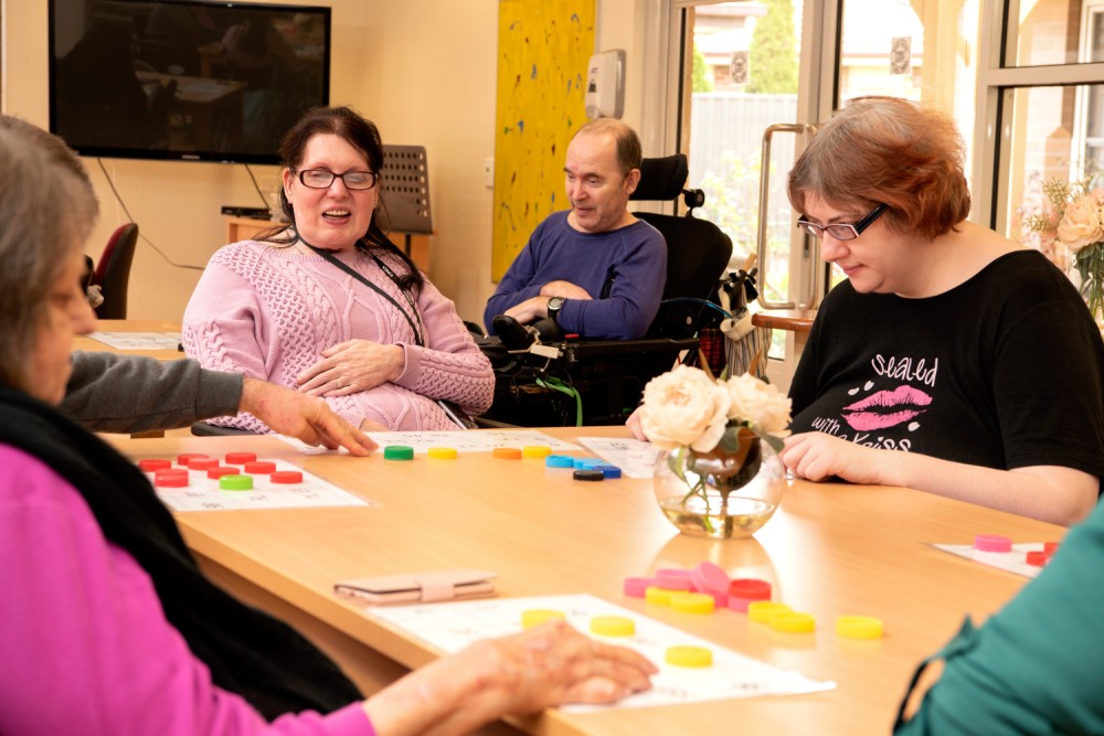 Residents playing tabletop game at Cyril Jewell House